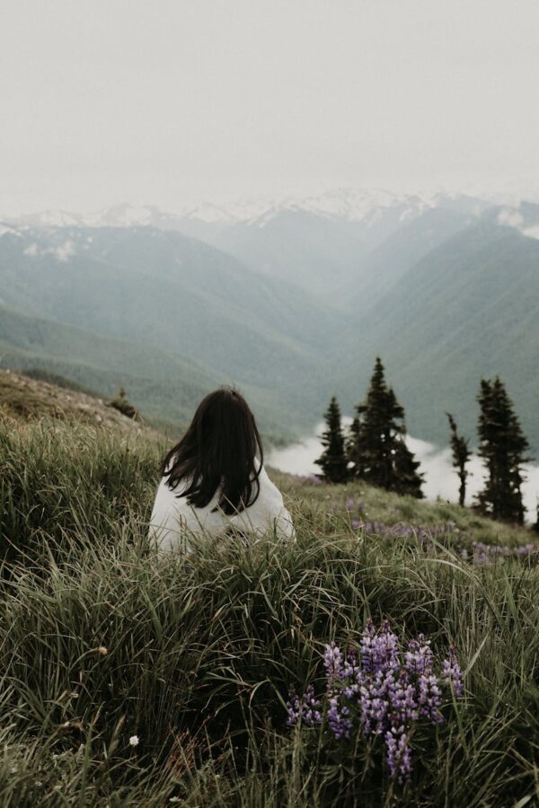 living the transfiguration - woman looking at majestic mountains