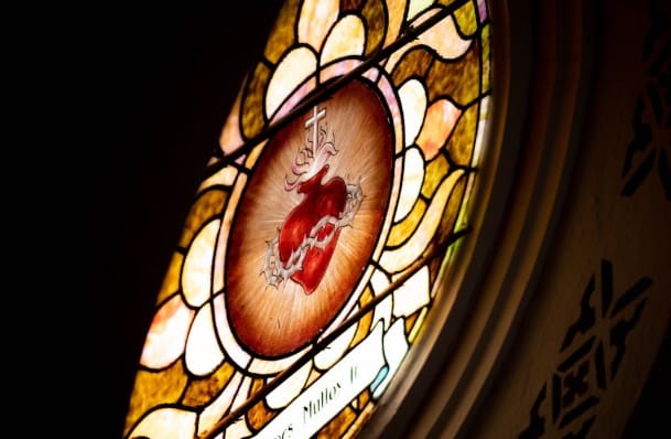 stained glass image of the sacred heart of Jesus via unsplash