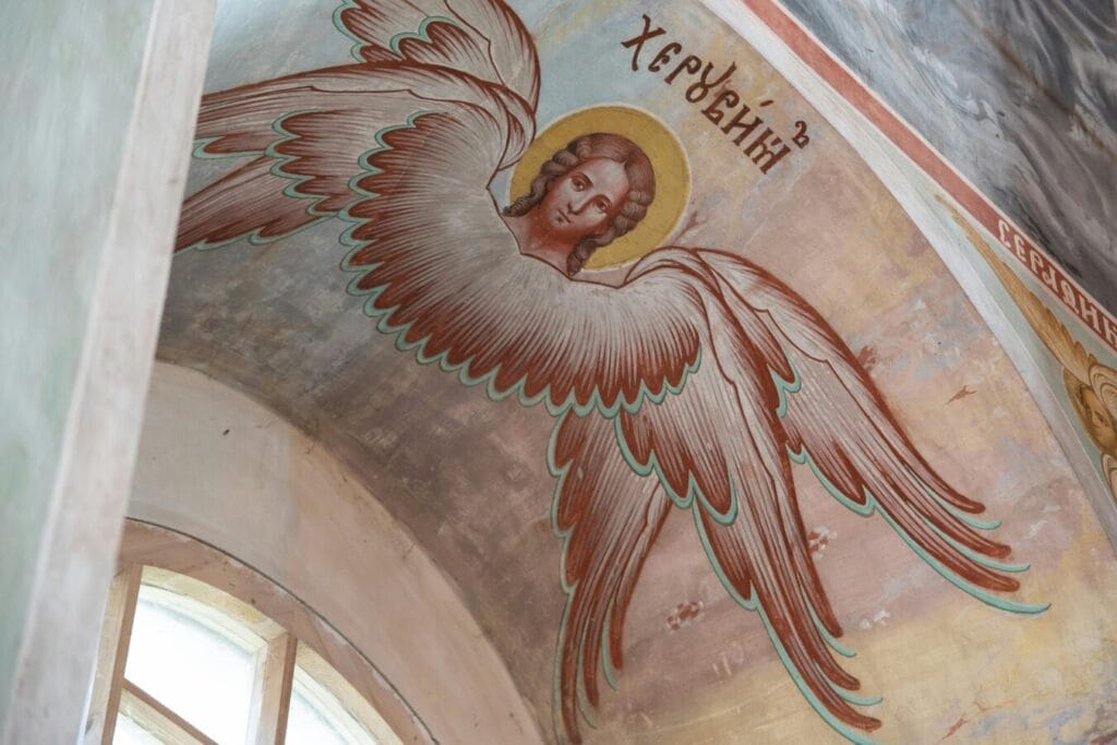 Artistic fresco of an angel painted on a church ceiling, depicting religious iconography.